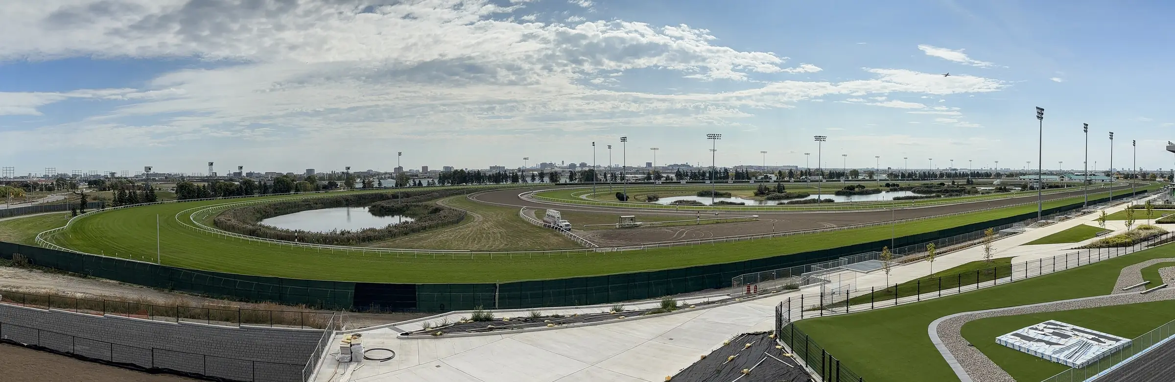 Wide view of the Woodbine oval in Etobicoke: turf course, all-weather main track and the infield lake